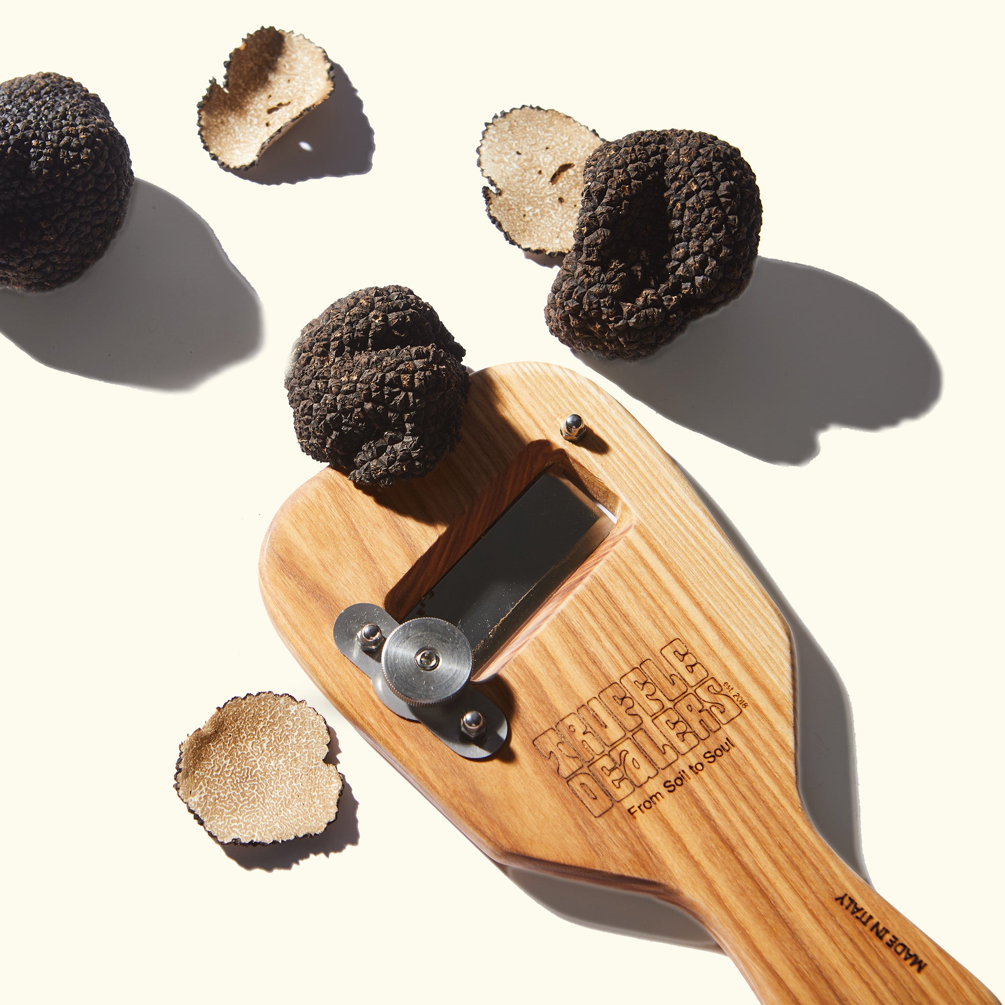 a close up of a wooden paddle with some kind of food on it