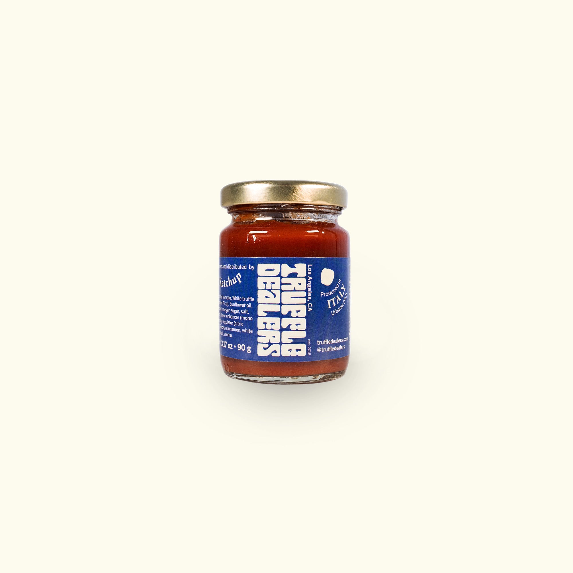 a jar of red sauce sitting on top of a white table