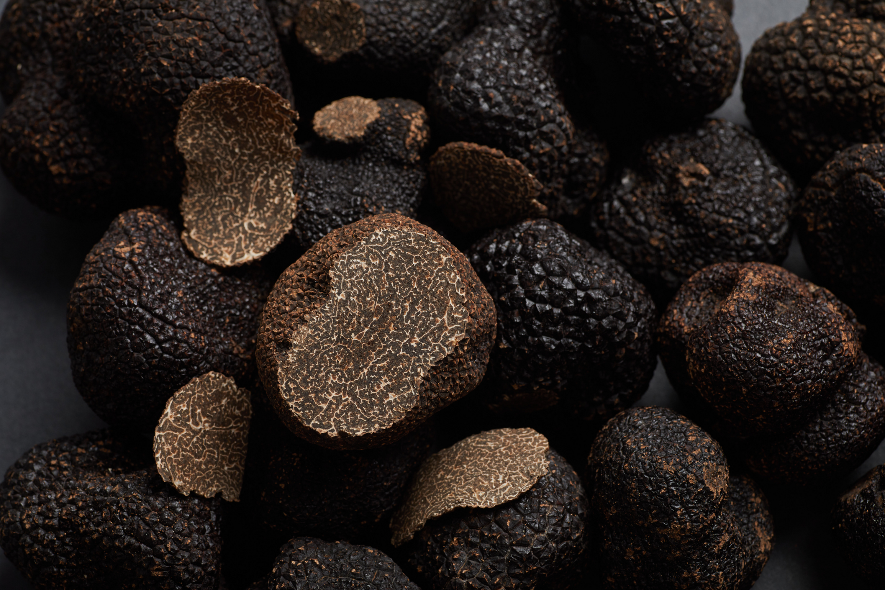 a pile of black truffles sitting on top of a table